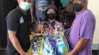 ASC Pengurus ASC Nicho Tulalessy dan Jan Silooy menyerahkan bantuan beras kepada salah satu dari 52 KK warga Amahusu, Sabtu (20/11). Foto Rudi Fofid